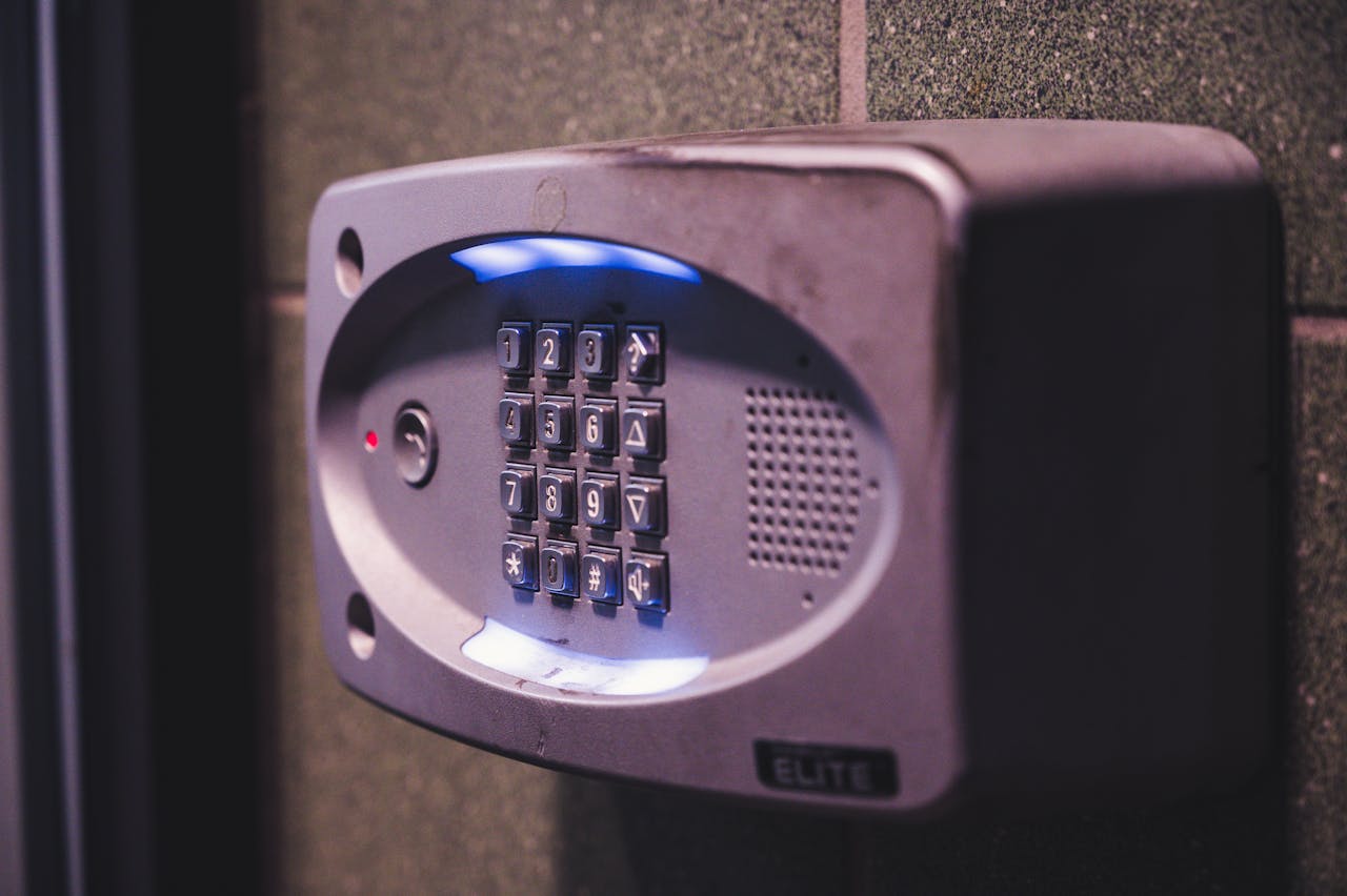 Home A close-up image of an illuminated security keypad mounted on a wall.